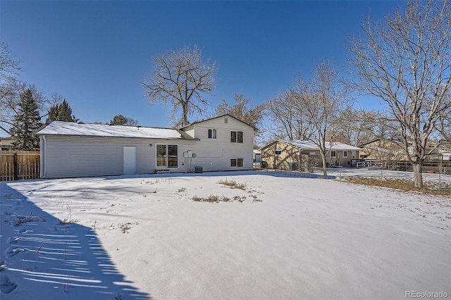 view of snow covered rear of property