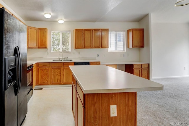 kitchen featuring a wealth of natural light, a center island, sink, and black appliances