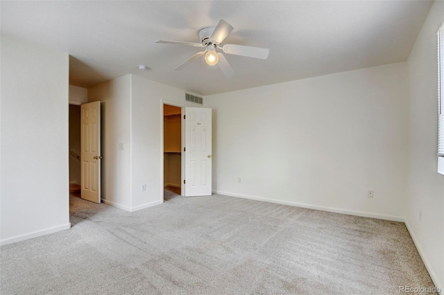 empty room with light colored carpet and ceiling fan