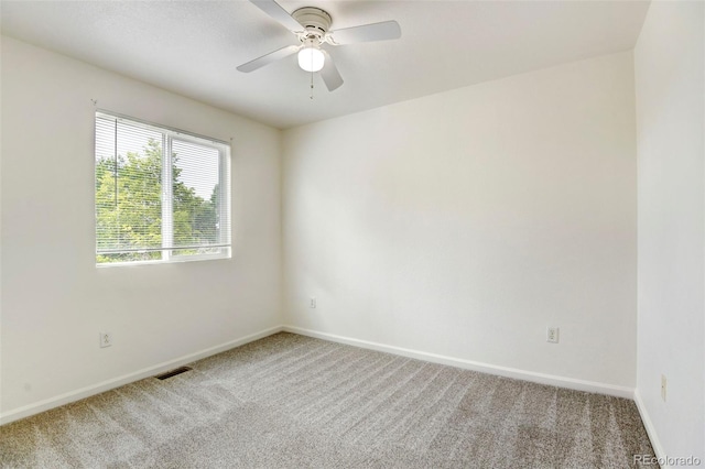 spare room with ceiling fan and carpet floors