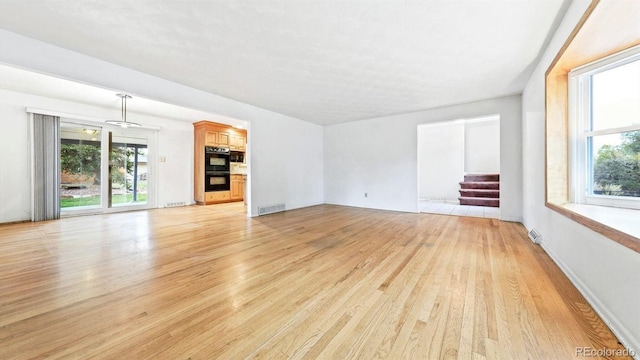 unfurnished living room featuring light hardwood / wood-style flooring