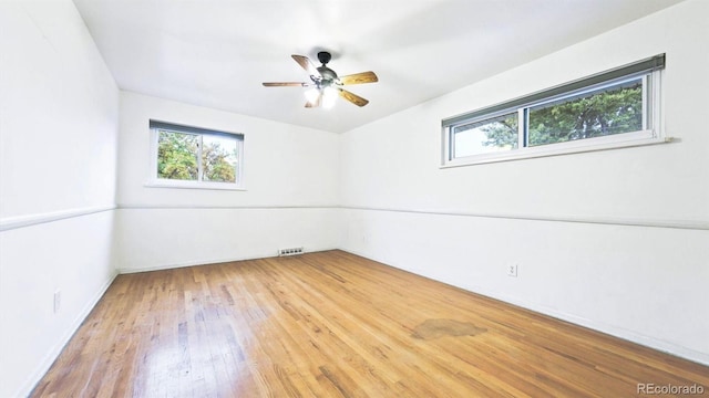 empty room with wood-type flooring and ceiling fan