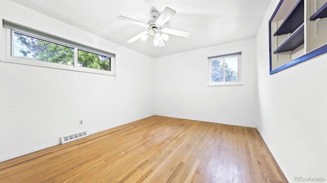 unfurnished room with ceiling fan and wood-type flooring