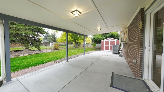 view of patio / terrace with central AC and a shed