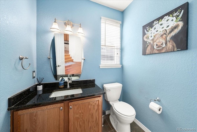 2730 River View Dr, Broomfield, CO 80023 - half bathroom featuring toilet, vanity, and baseboards
