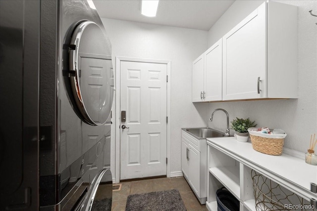 2730 River View Dr, Broomfield, CO 80023 - laundry room featuring cabinet space and stacked washer / dryer