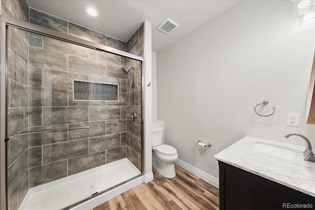 2730 River View Dr, Broomfield, CO 80023 - bathroom with toilet, vanity, a shower stall, baseboards, and wood finished floors