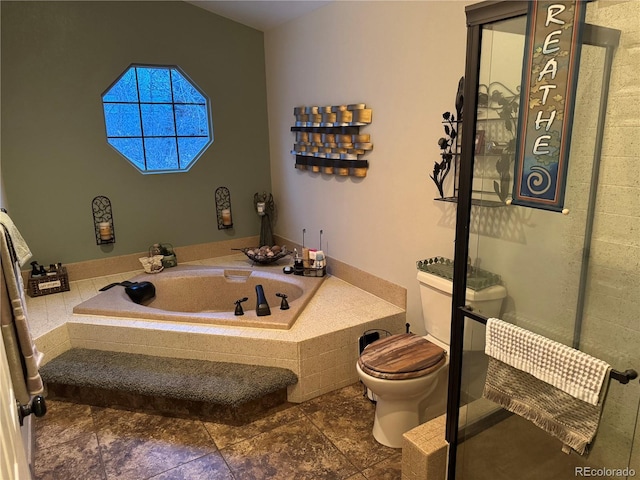 full bathroom featuring a bath and toilet