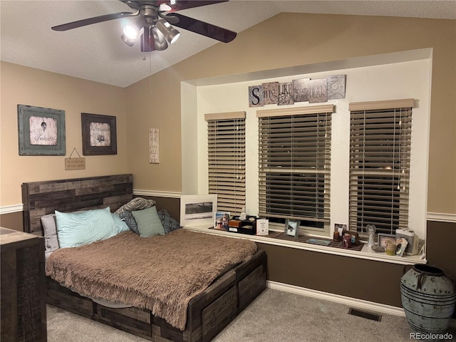 bedroom with carpet floors, a ceiling fan, visible vents, vaulted ceiling, and baseboards