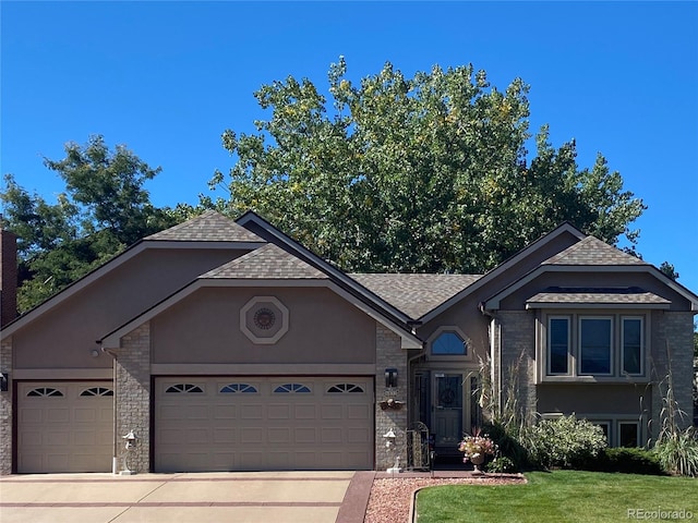 view of front of house with concrete driveway, an attached garage, and stucco siding