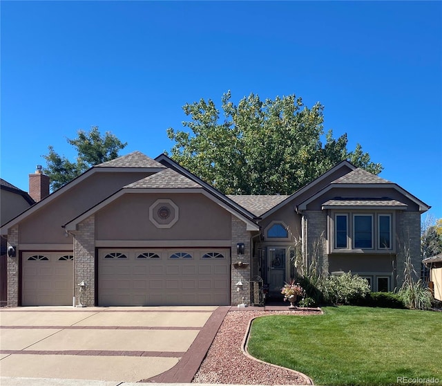 view of front of home with brick siding, stucco siding, concrete driveway, a front yard, and a garage