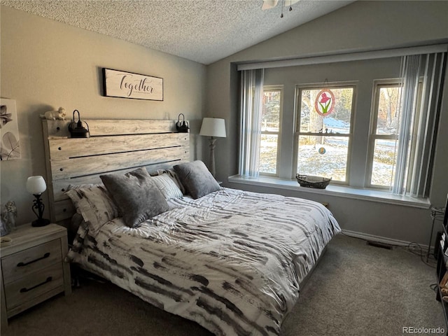 bedroom with a textured ceiling, visible vents, vaulted ceiling, and carpet flooring