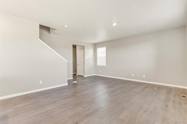 unfurnished room with light wood-type flooring