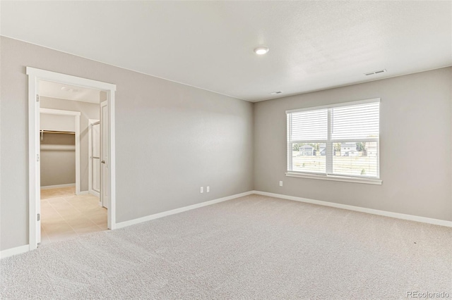 spare room featuring light colored carpet