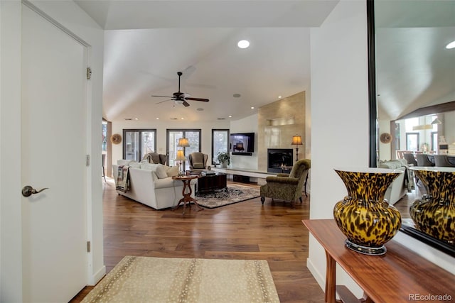 living room with ceiling fan and dark wood-type flooring