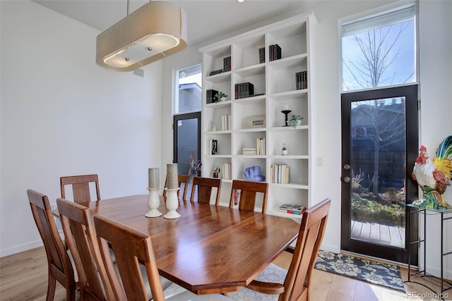 dining space with light hardwood / wood-style flooring