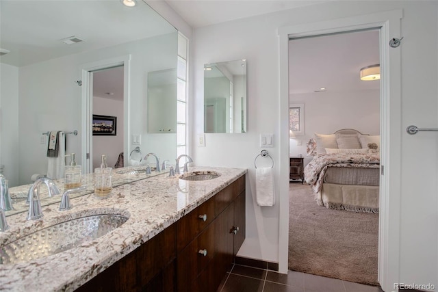 bathroom with tile patterned floors and vanity