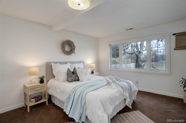 bedroom with dark colored carpet and beamed ceiling