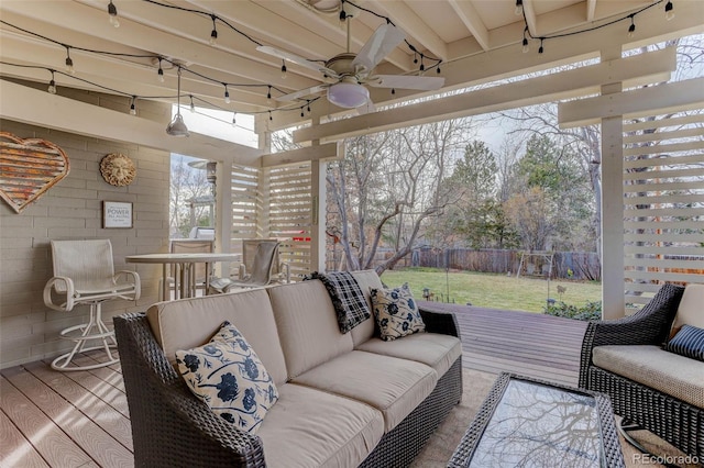 wooden terrace with an outdoor living space