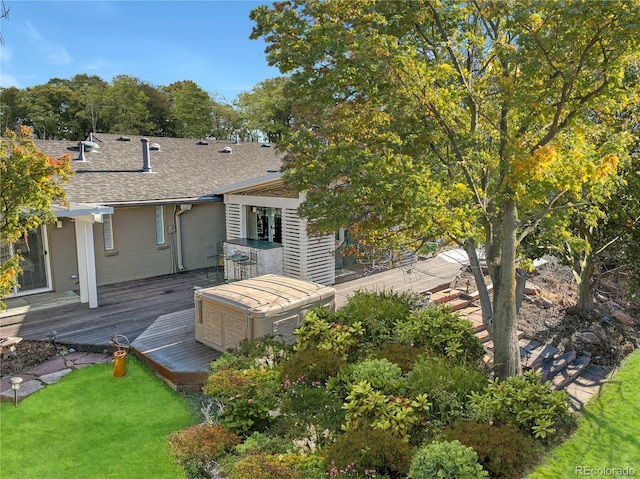 rear view of house with a yard and a wooden deck