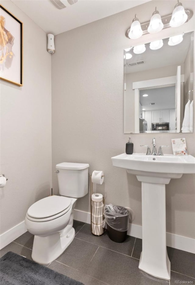 bathroom featuring tile patterned floors and toilet