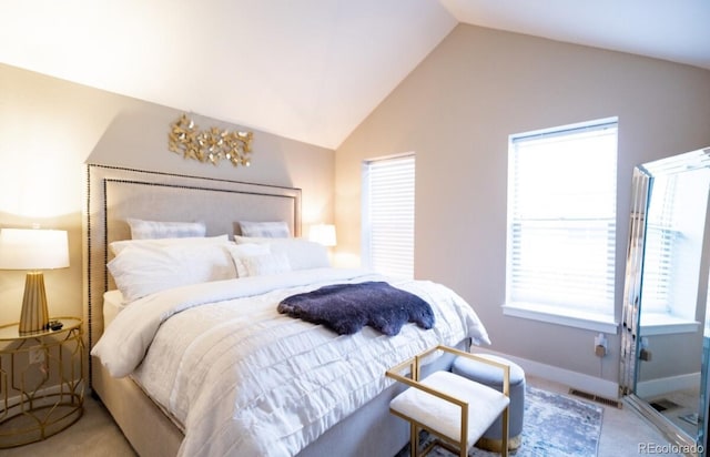 bedroom with lofted ceiling, multiple windows, and light colored carpet