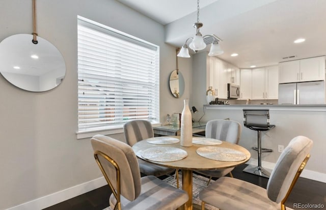 dining space with dark wood-type flooring