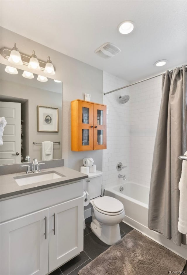 full bathroom with vanity, shower / bath combination with curtain, toilet, and tile patterned floors