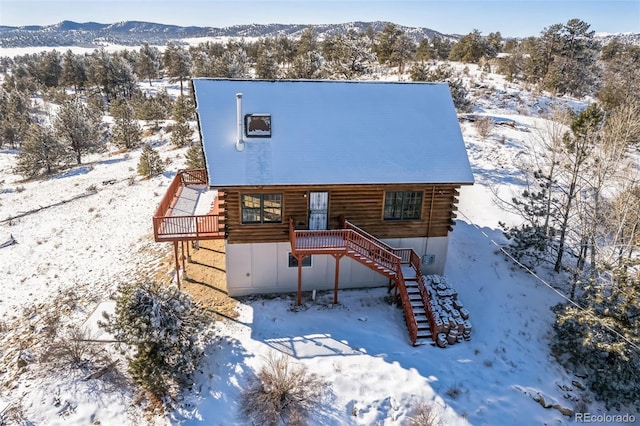 view of front of property with a deck with mountain view