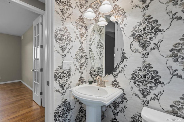 17223 W 84th Dr, Arvada, CO 80007 - half bathroom with wood finished floors, toilet, and baseboards