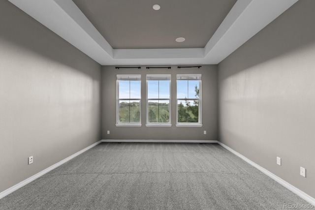 17223 W 84th Dr, Arvada, CO 80007 - carpeted empty room featuring a tray ceiling and baseboards