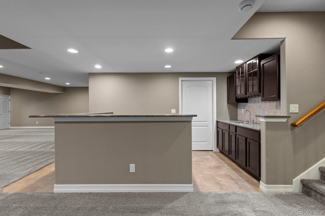 17223 W 84th Dr, Arvada, CO 80007 - kitchen with light carpet, a sink, recessed lighting, dark brown cabinets, and a center island