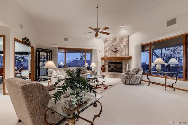 7769 W 70th Dr, Arvada, CO 80004 - living area featuring a ceiling fan, healthy amount of natural light, a fireplace, and carpet flooring