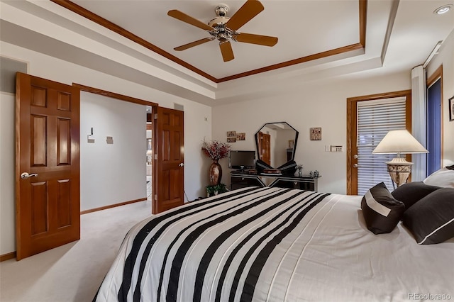 7769 W 70th Dr, Arvada, CO 80004 - bedroom with light carpet, a tray ceiling, crown molding, and ceiling fan