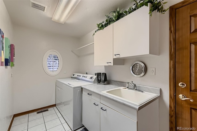 7769 W 70th Dr, Arvada, CO 80004 - laundry room featuring independent washer and dryer, cabinet space, and light tile patterned floors