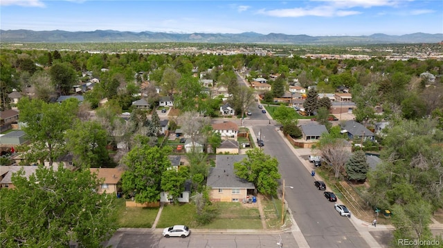 aerial view of property's location with a mountain backdrop and nearby suburban area
