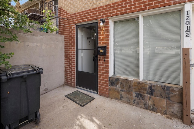 property entrance with brick siding