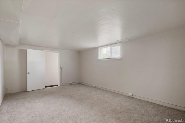 basement featuring light colored carpet