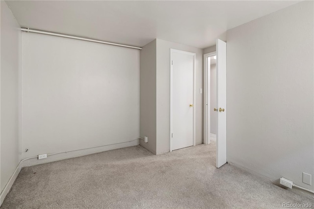 unfurnished bedroom with carpet flooring and baseboards