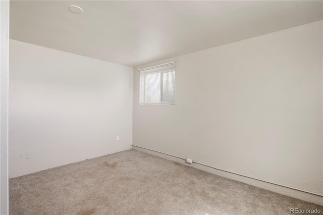 spare room with light colored carpet