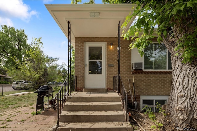 doorway to property with brick siding