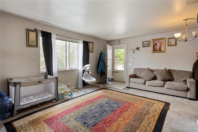 living room with a chandelier and carpet