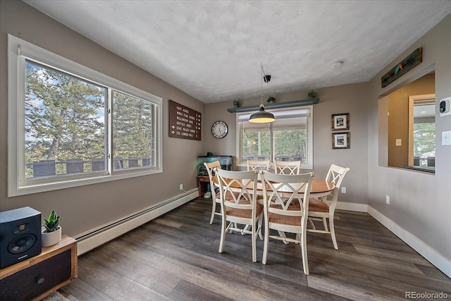 dining room with a baseboard radiator, dark wood-type flooring, and a textured ceiling