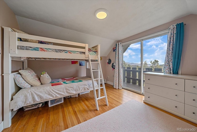 bedroom featuring vaulted ceiling and light wood-type flooring