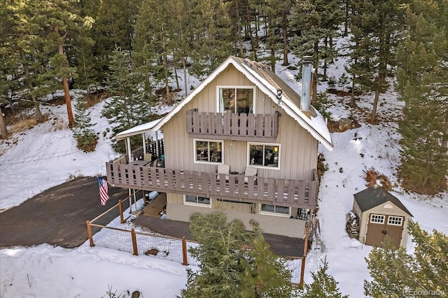 snow covered house with a balcony