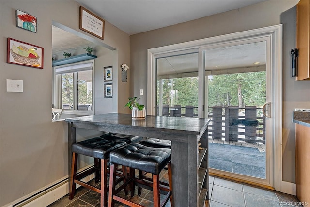 kitchen featuring a kitchen breakfast bar and tile floors