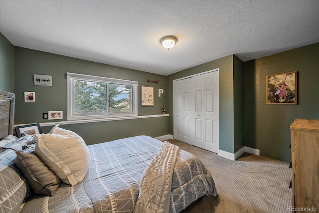 carpeted bedroom with a closet and a textured ceiling