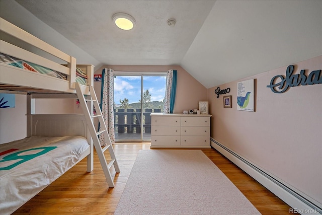 bedroom with baseboard heating, light hardwood / wood-style flooring, access to outside, and vaulted ceiling