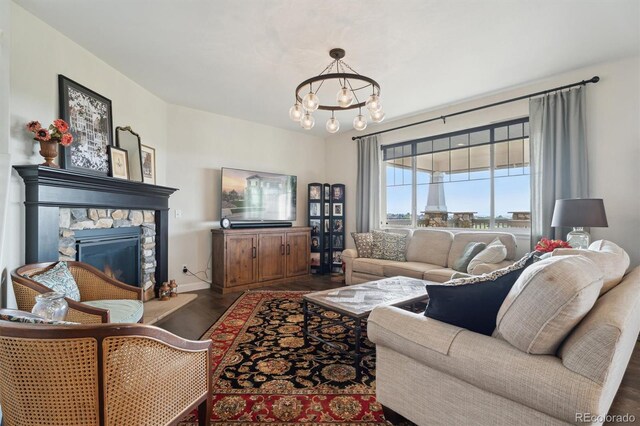 3741 Harvard Pl, Broomfield, CO 80023 - living area with a chandelier, wood finished floors, and a stone fireplace