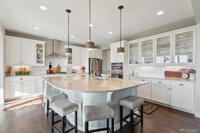 3741 Harvard Pl, Broomfield, CO 80023 - kitchen with wall chimney range hood, stainless steel appliances, decorative backsplash, white cabinetry, and recessed lighting